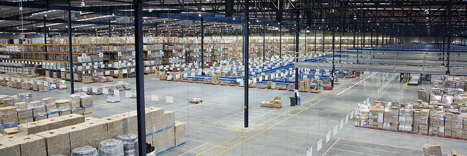 The inside of a large warehouse with many pallets
